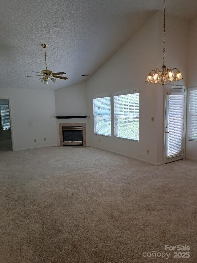 4 Gatehouse Ct, Asheville, NC 28803 - unfurnished living room featuring high vaulted ceiling, ceiling fan, a tiled fireplace, a textured ceiling, and carpet flooring
