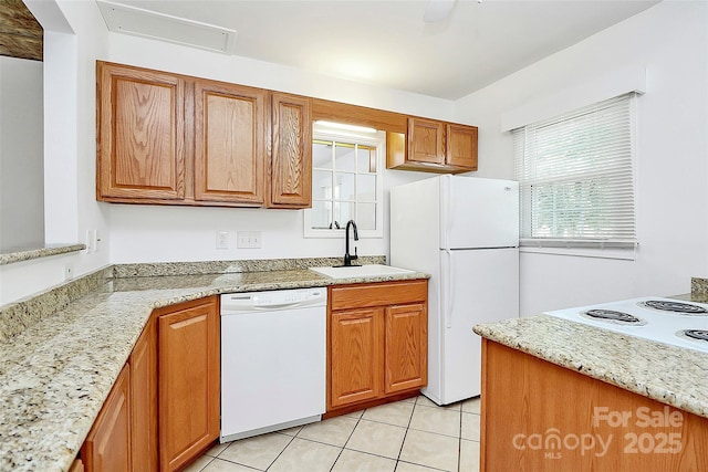 8062 Knights Bridge Rd, Charlotte, NC 28210 - kitchen featuring white appliances, light tile patterned floors, brown cabinetry, and light stone counters