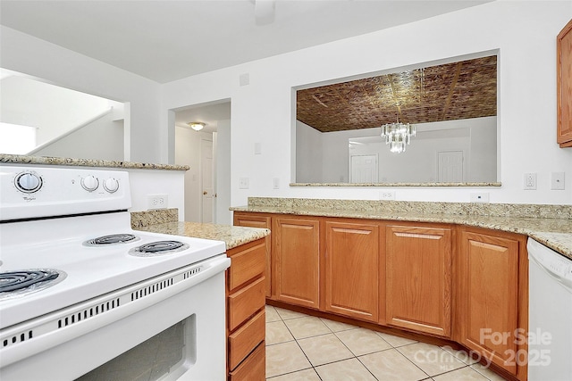 8062 Knights Bridge Rd, Charlotte, NC 28210 - kitchen featuring white appliances, a chandelier, light tile patterned floors, light stone countertops, and brown cabinets