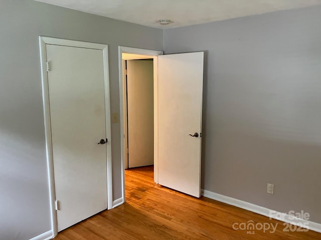 615 Marietta St, Asheville, NC 28803 - unfurnished bedroom with light wood-type flooring and baseboards