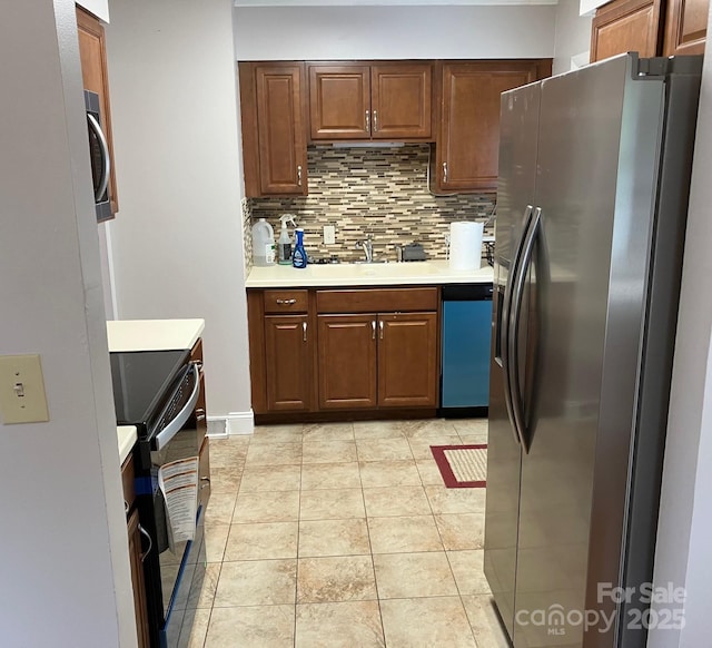 615 Marietta St, Asheville, NC 28803 - kitchen with stainless steel appliances, light countertops, decorative backsplash, and light tile patterned floors