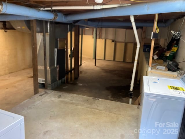 615 Marietta St, Asheville, NC 28803 - unfinished below grade area featuring washer and dryer