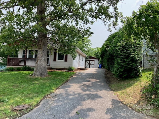 615 Marietta St, Asheville, NC 28803 - view of front of house with an outdoor structure, a front yard, and a detached garage