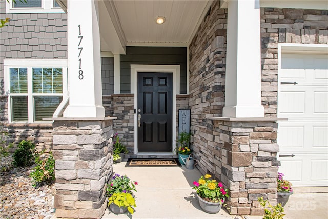 17718 Terryglass Ln, Charlotte, NC 28278 - property entrance with covered porch, stone siding, and a garage