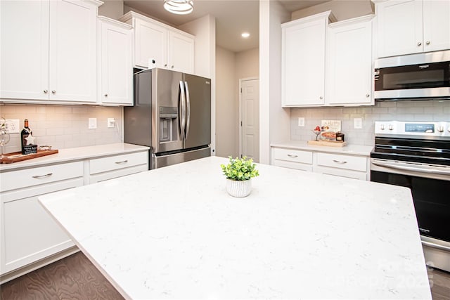 17718 Terryglass Ln, Charlotte, NC 28278 - kitchen featuring stainless steel appliances, white cabinets, a kitchen island, backsplash, and recessed lighting