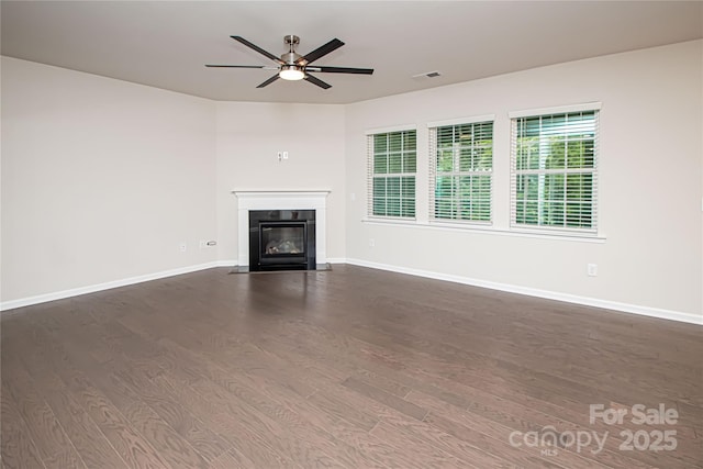 17718 Terryglass Ln, Charlotte, NC 28278 - unfurnished living room with dark wood-style flooring, a ceiling fan, and a fireplace with flush hearth