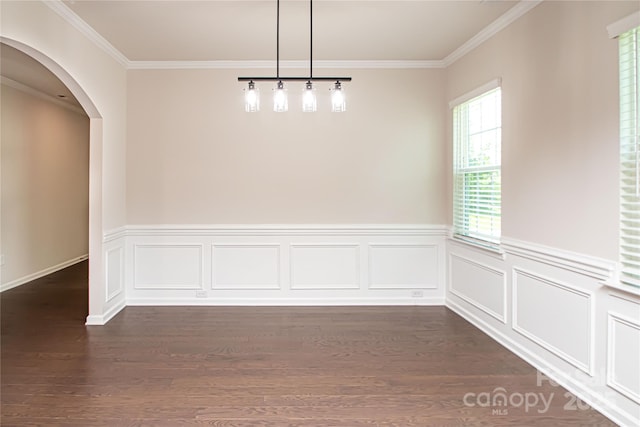 17718 Terryglass Ln, Charlotte, NC 28278 - unfurnished dining area featuring arched walkways, ornamental molding, dark wood-style flooring, and a wainscoted wall