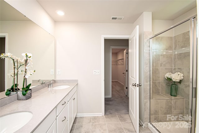 17718 Terryglass Ln, Charlotte, NC 28278 - full bathroom with double vanity, a stall shower, a walk in closet, and tile patterned floors