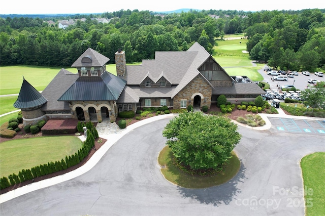 17718 Terryglass Ln, Charlotte, NC 28278 - view of front facade with stone siding, a chimney, a metal roof, and a standing seam roof