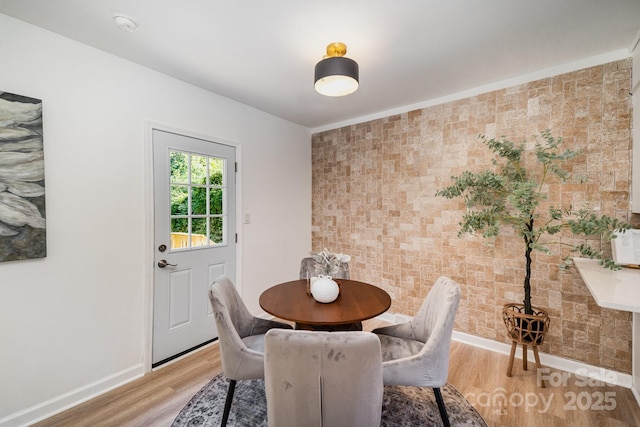 3427 Wonderland Dr, Matthews, NC 28104 - dining area featuring an accent wall and light wood-style flooring