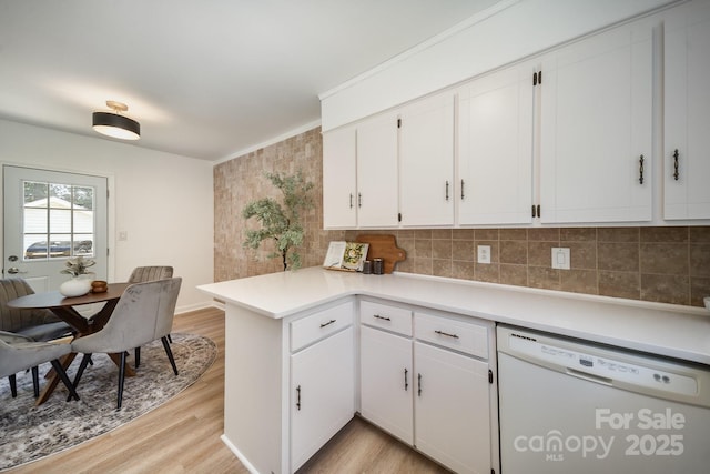 3427 Wonderland Dr, Matthews, NC 28104 - kitchen with white dishwasher, light wood-style floors, tasteful backsplash, and white cabinets