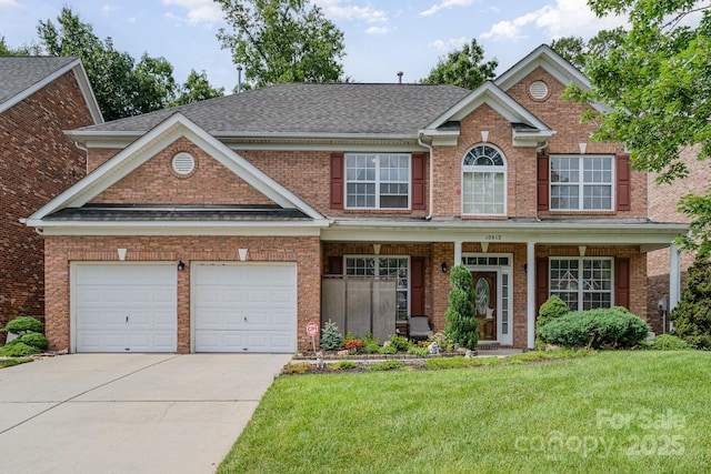 10812 Clark St, Davidson, NC 28036 - view of front of property with concrete driveway, a front yard, brick siding, and a shingled roof