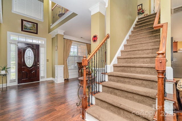 10812 Clark St, Davidson, NC 28036 - entrance foyer featuring wood finished floors, stairs, a towering ceiling, and ornamental molding