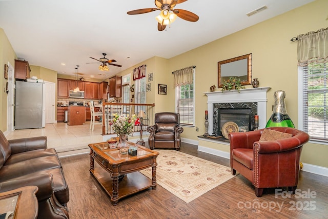 10812 Clark St, Davidson, NC 28036 - living room with a ceiling fan, light wood-type flooring, a fireplace, and recessed lighting