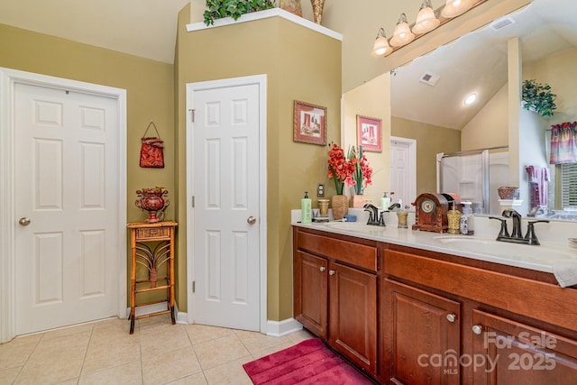 10812 Clark St, Davidson, NC 28036 - full bathroom featuring lofted ceiling, tile patterned floors, double vanity, and an enclosed shower