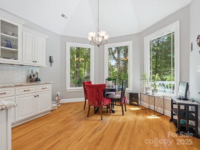 13101 Kensworth Ct, Charlotte, NC 28277 - dining room featuring vaulted ceiling, light wood-style floors, and a chandelier