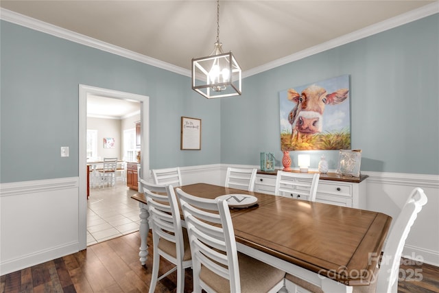4114 Flint Dr, Lancaster, SC 29720 - dining space with crown molding, a chandelier, wainscoting, and hardwood / wood-style floors