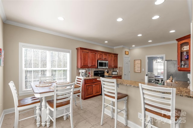 4114 Flint Dr, Lancaster, SC 29720 - kitchen with stainless steel microwave, recessed lighting, healthy amount of natural light, tasteful backsplash, and a peninsula