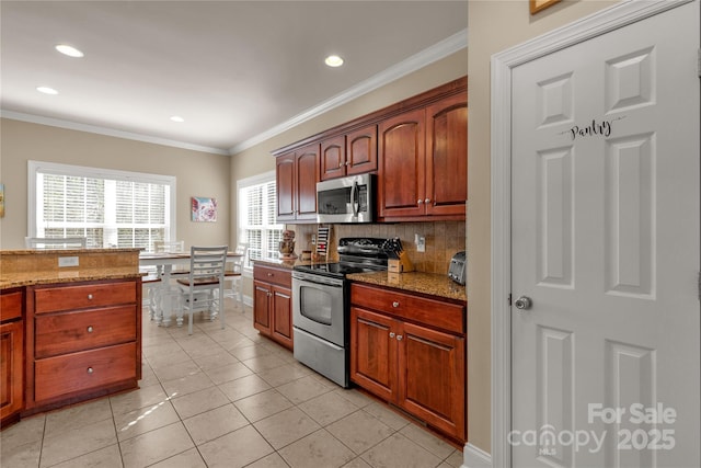 4114 Flint Dr, Lancaster, SC 29720 - kitchen featuring appliances with stainless steel finishes, decorative backsplash, recessed lighting, crown molding, and light stone countertops