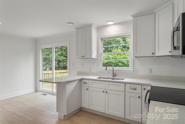 4146 Old State Rd, Newton, NC 28658 - kitchen with a peninsula, crown molding, light countertops, and healthy amount of natural light