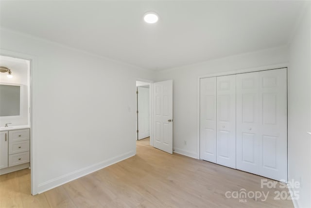 4146 Old State Rd, Newton, NC 28658 - unfurnished bedroom with light wood-style flooring, a closet, crown molding, and ensuite bathroom