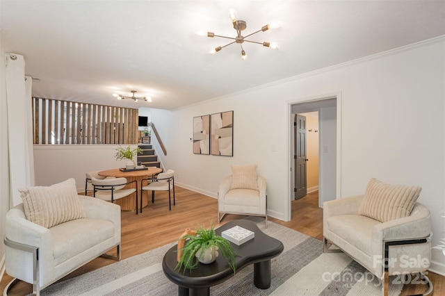 8025 Cliffside Dr, Charlotte, NC 28270 - living room featuring a chandelier, stairs, light wood-style flooring, and crown molding