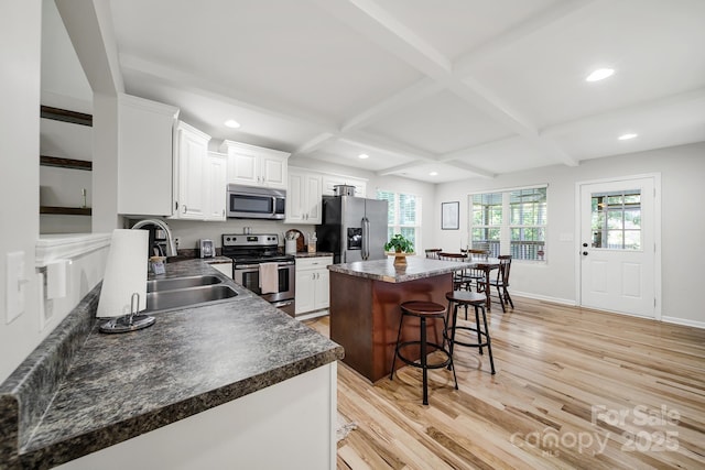 224 Eagle Creek Rd, Clover, SC 29710 - kitchen with stainless steel appliances, dark countertops, a center island, a breakfast bar area, and recessed lighting