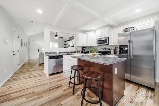 224 Eagle Creek Rd, Clover, SC 29710 - kitchen with appliances with stainless steel finishes, light wood-style floors, a center island, a ceiling fan, and white cabinets