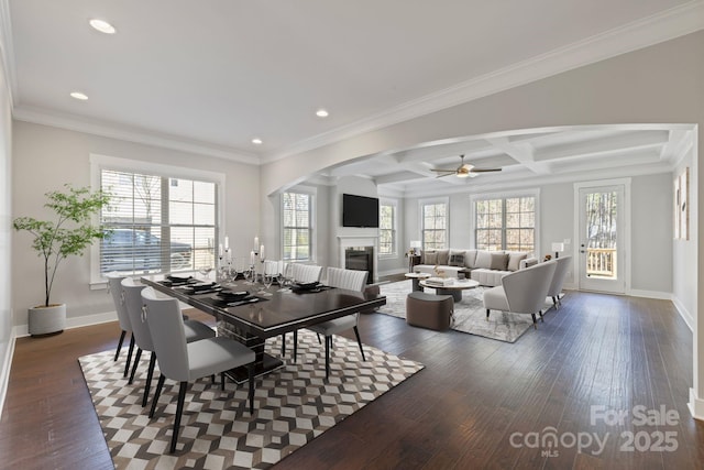 704 Kenway Loop, Mooresville, NC 28117 - dining space with a glass covered fireplace, healthy amount of natural light, a ceiling fan, dark wood-type flooring, and beam ceiling