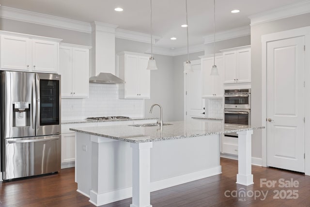 704 Kenway Loop, Mooresville, NC 28117 - kitchen with appliances with stainless steel finishes, wall chimney range hood, decorative backsplash, a center island with sink, and recessed lighting