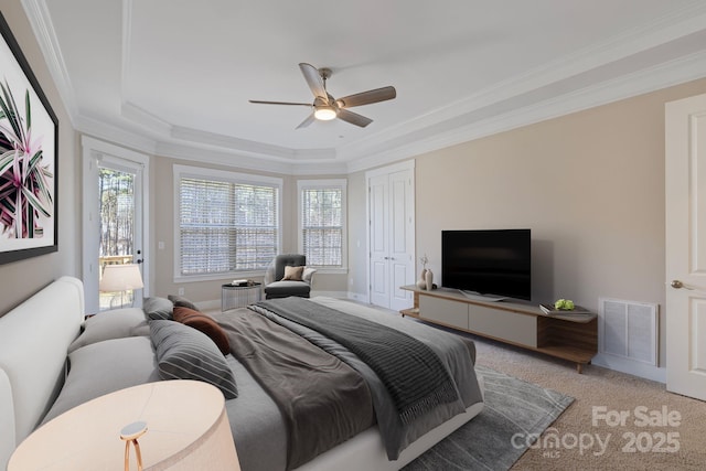 704 Kenway Loop, Mooresville, NC 28117 - bedroom featuring light carpet, a tray ceiling, crown molding, multiple windows, and a ceiling fan