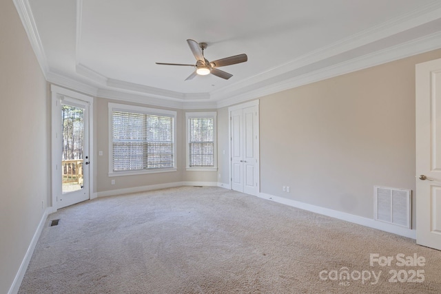 704 Kenway Loop, Mooresville, NC 28117 - unfurnished bedroom featuring carpet flooring, ornamental molding, a tray ceiling, access to outside, and multiple windows