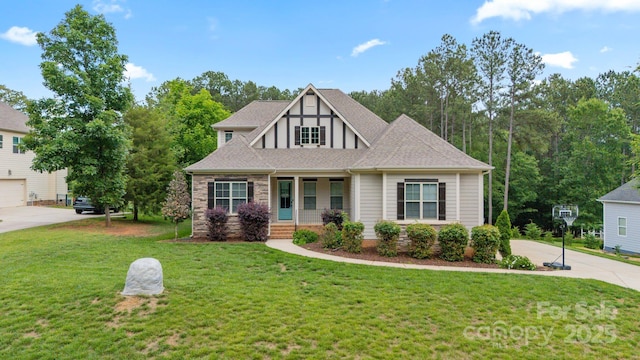 704 Kenway Loop, Mooresville, NC 28117 - view of front of house with a front yard, covered porch, roof with shingles, and driveway