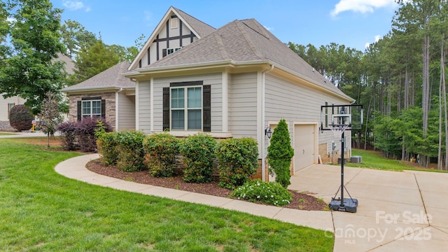 704 Kenway Loop, Mooresville, NC 28117 - view of side of home with concrete driveway, a lawn, a garage, and stone siding