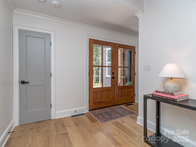 202 Walden Ln, Weddington, NC 28104 - foyer entrance featuring light wood finished floors, crown molding, and french doors