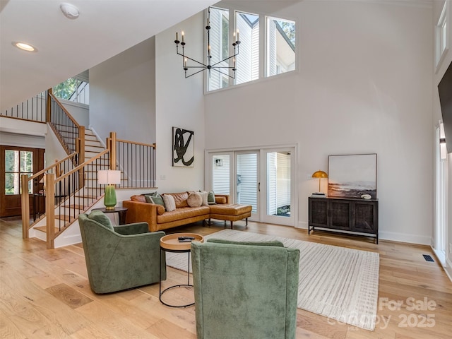 202 Walden Ln, Weddington, NC 28104 - living room with a high ceiling, a chandelier, stairs, light wood-style flooring, and recessed lighting