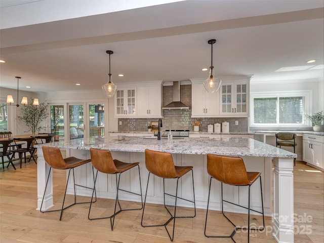 202 Walden Ln, Weddington, NC 28104 - kitchen with wall chimney exhaust hood, white cabinets, tasteful backsplash, light wood finished floors, and recessed lighting