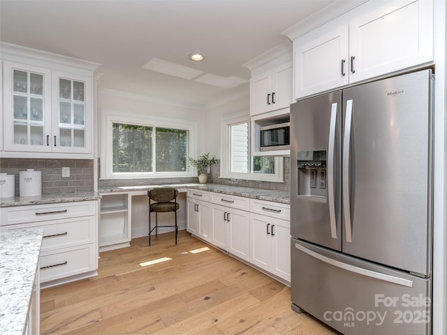 202 Walden Ln, Weddington, NC 28104 - kitchen featuring appliances with stainless steel finishes, white cabinets, ornamental molding, light wood-style floors, and glass insert cabinets