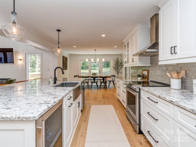202 Walden Ln, Weddington, NC 28104 - kitchen with stainless steel stove, wall chimney exhaust hood, beverage cooler, white cabinetry, and recessed lighting
