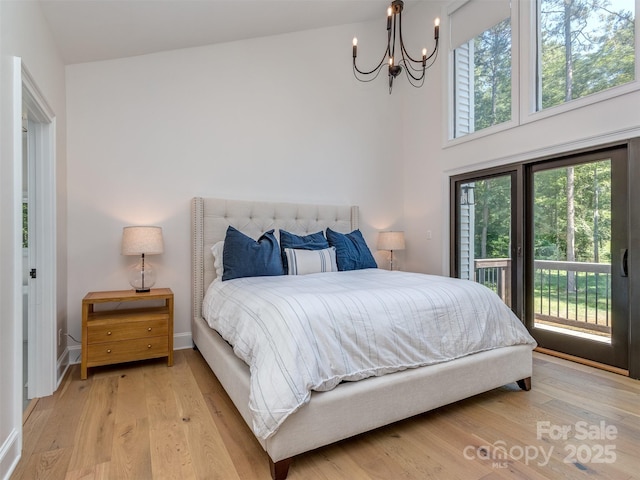 202 Walden Ln, Weddington, NC 28104 - bedroom featuring access to outside, a chandelier, and light wood-style floors