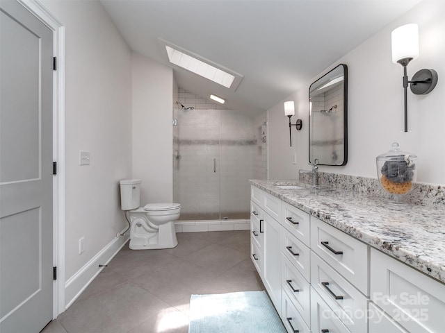 202 Walden Ln, Weddington, NC 28104 - bathroom featuring a skylight, vaulted ceiling, a shower stall, vanity, and tile patterned floors