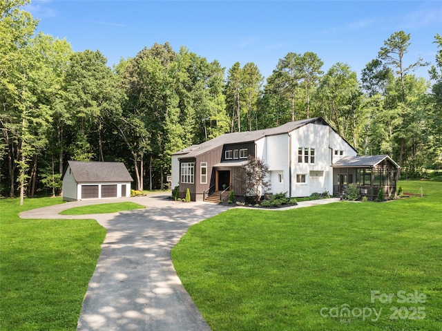 202 Walden Ln, Weddington, NC 28104 - view of front of home with an outbuilding, a garage, a front yard, and a sunroom