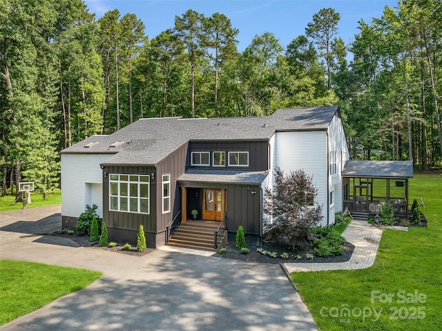 202 Walden Ln, Weddington, NC 28104 - view of front of house with a porch, board and batten siding, a front yard, and roof with shingles