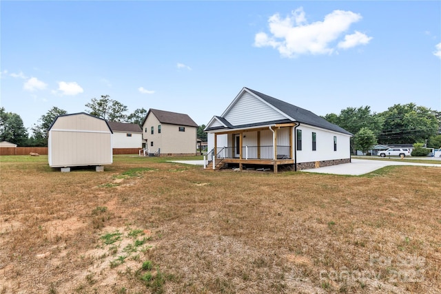 3511 Warlicks Church Rd, Connelly Springs, NC 28612 - back of property with covered porch, a yard, and a storage unit