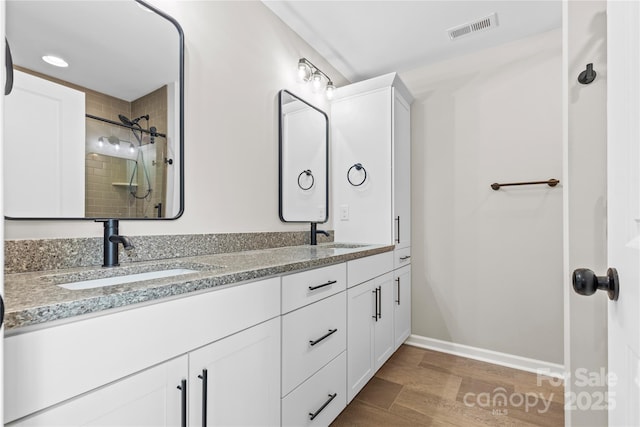 3511 Warlicks Church Rd, Connelly Springs, NC 28612 - full bathroom with double vanity, tiled shower, and wood finished floors