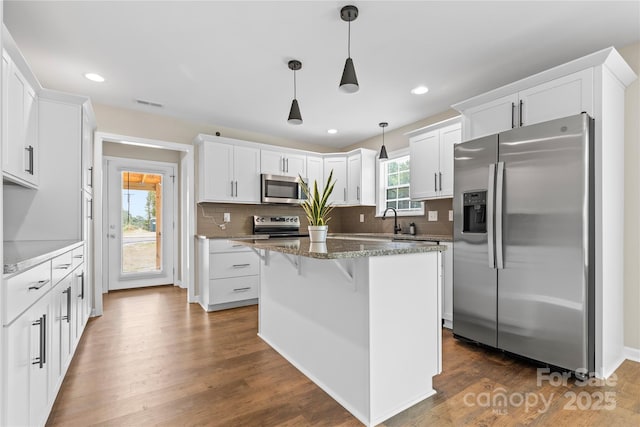 3511 Warlicks Church Rd, Connelly Springs, NC 28612 - kitchen featuring appliances with stainless steel finishes, decorative backsplash, white cabinetry, a kitchen breakfast bar, and recessed lighting