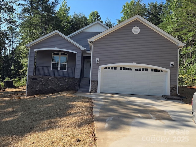 153 Brook Creek Dr, Troutman, NC 28166 - view of front facade featuring covered porch, concrete driveway, a garage, and brick siding