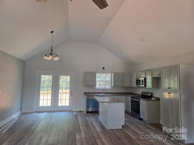 153 Brook Creek Dr, Troutman, NC 28166 - kitchen with appliances with stainless steel finishes, a center island, dark wood-style flooring, high vaulted ceiling, and pendant lighting
