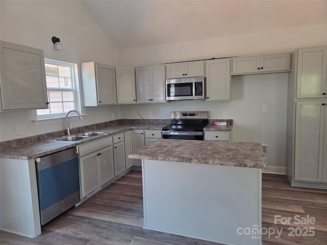 153 Brook Creek Dr, Troutman, NC 28166 - kitchen featuring stainless steel appliances, dark wood-style floors, a kitchen island, and high vaulted ceiling