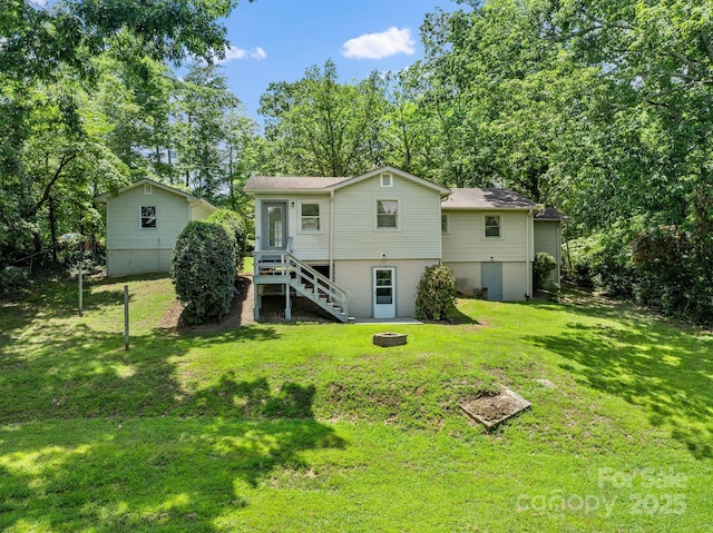 211 Woodland Rd, Tryon, NC 28782 - back of house with stairs, a fire pit, a lawn, and view of wooded area